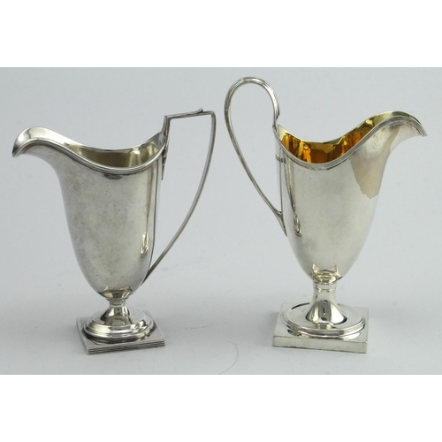 445 - Two Georgian style silver helmet shaped cream jugs, hallmarked JD&S Sheffield 1929 & AMW London 1977... 