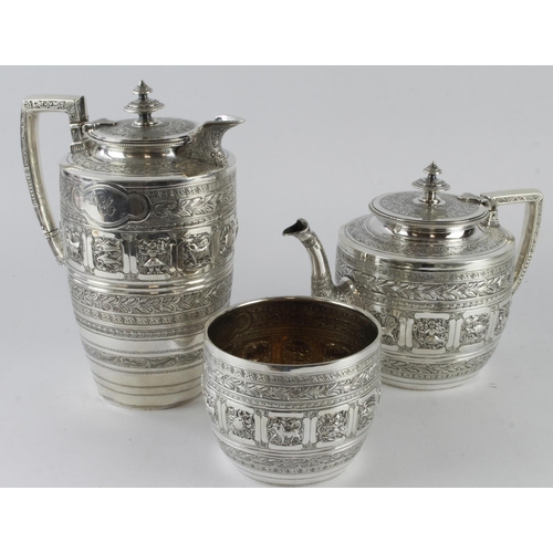 478 - Silver three piece tea & coffee set, comprising teapot, coffee pot and sugar bowl, ornately decorate... 