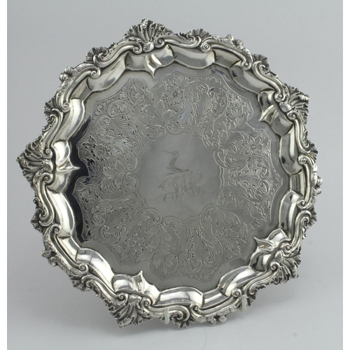 529 - William IV silver tray, raised on three feet, ornately decorated, crest and monogram to centre, hall... 