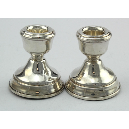 531 - Pair of silver dwarf candlesticks hallmarked B&Co. Birm. 1974 - both have loaded bases