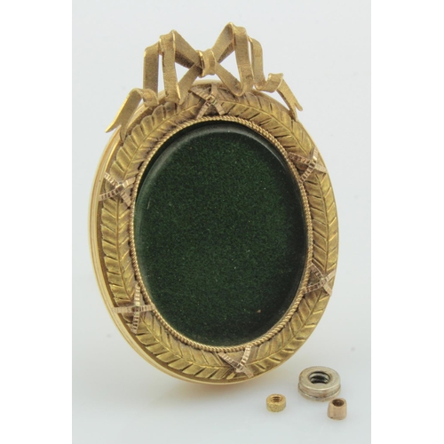 540 - Faberge style ornate miniature oval easel back picture frame, wreath motif, bow and back fitting tes... 