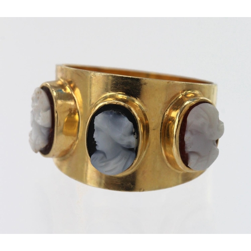 577 - Yellow gold (tests 14ct) cameo trilogy ring, two carved shells and one carved onyx all depicting a l... 