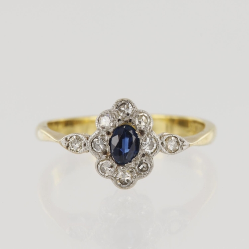 653 - Yellow gold (tests 18ct) vintage diamond and sapphire cluster ring, one oval sapphire approx. 4mm x ... 