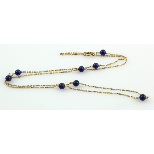 800 - Yellow gold (tests 9ct) lapis lazuli station necklet, eight approx. 4mm lapis lazuli beads spaced in... 