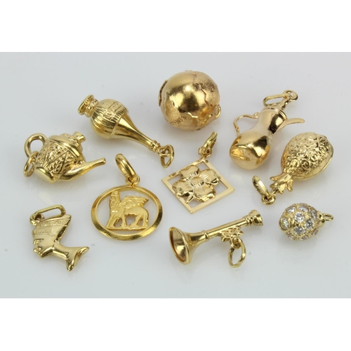 803 - Ten yellow gold (tests 18ct) charms, total weight 21.5g.