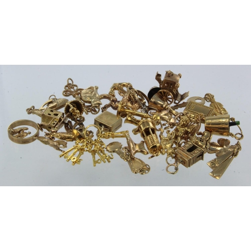 929 - Thirty-eight 9ct gold/tests 9ct novelty charms, total weight 69.3g.