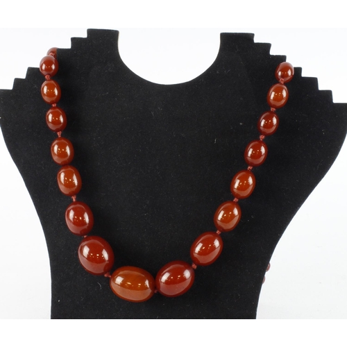 963 - Cherry red bakelite single row beaded necklace, sixty-nine graduating beads, largest bead approx. 31... 