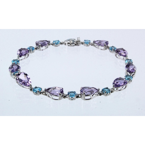 968 - 18ct white gold amethyst and Swiss blue topaz bracelet, ten pear cut amethysts approx. 9mm x 6mm eac... 