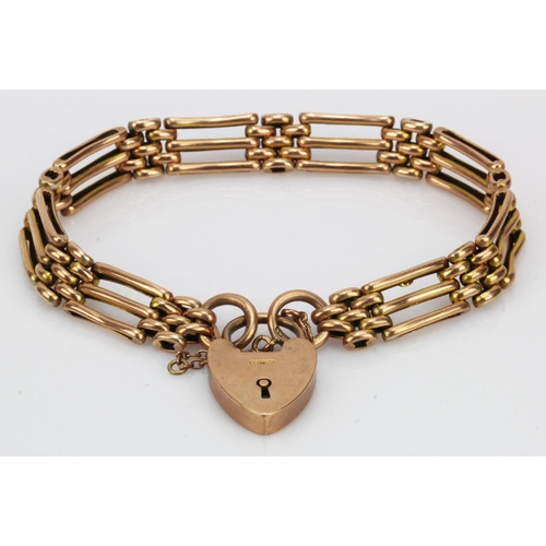 975 - Rose gold (tests 9ct) three bar gate bracelet with heart padlock clasp, length 7.5