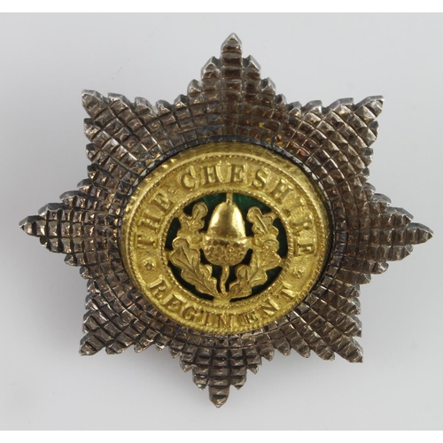 1000 - Cheshire Regiment silver plated cap badge maker marked 'Firmin London'.