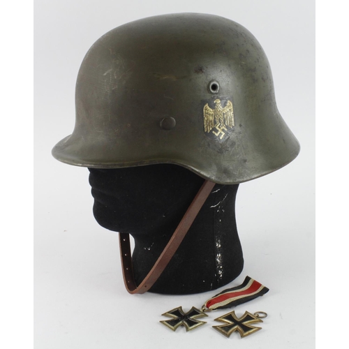 1127 - German 3rd Reich Helmet, repainted, later decals, and replacement liner. Helmet rim stamped '8714' a... 