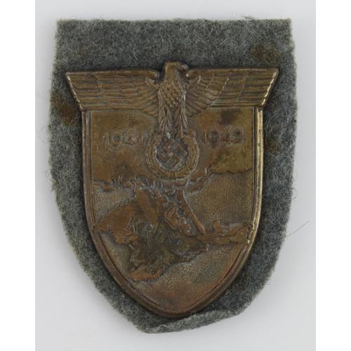 1196 - German Krim shield on wehrmacht cloth backing.