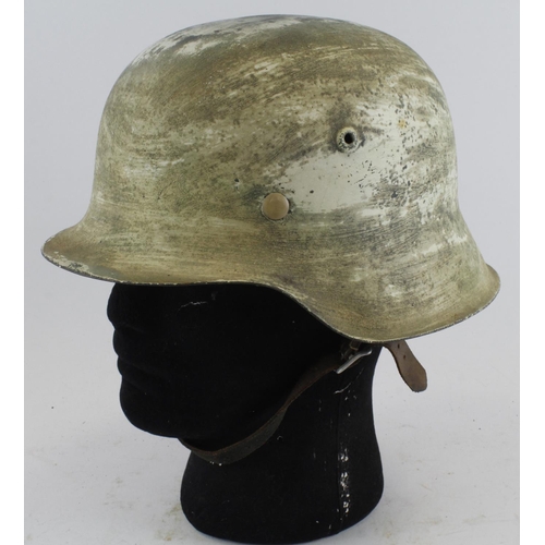 1289 - German WW2 1943 pattern raw edge helmet with snow camo.