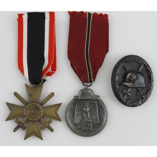 1296 - German WW2 group with War Merit Cross with swords, Russian Front medal, wound badge in black with or... 