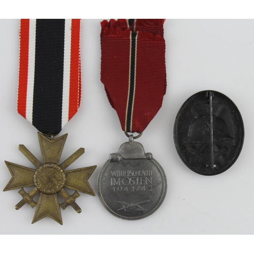 1296 - German WW2 group with War Merit Cross with swords, Russian Front medal, wound badge in black with or... 