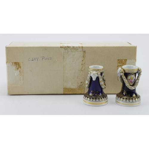 103 - Meissen. A pair of Meissen candlesticks with goat head, floral & gilt decoration,, makers marks to b... 