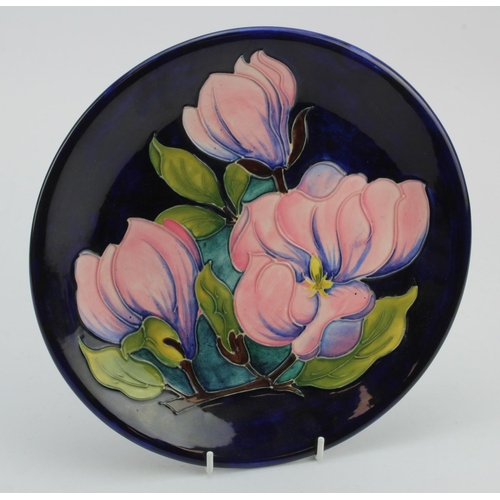 113 - Moorcroft 'Magnolia' pattern plate, makers marks to reverse, diameter 26cm approx.