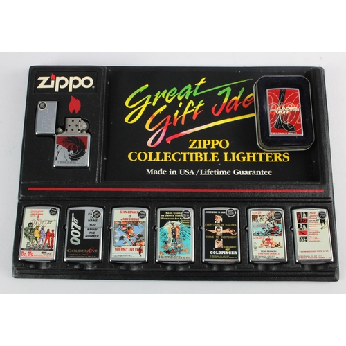 493 - Zippo Lighters. A collection of nine James Bond OO7 themed Zippo lighters