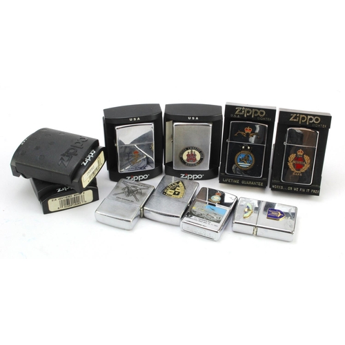 499 - Zippo Lighters. A collection of ten mostly Military & Naval related Zippo lighters, including Dambus... 