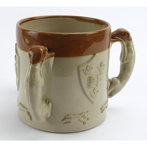 94 - Glazed stoneware three handled cup, with hunting scene and Oxford University coat of arms to side, h... 