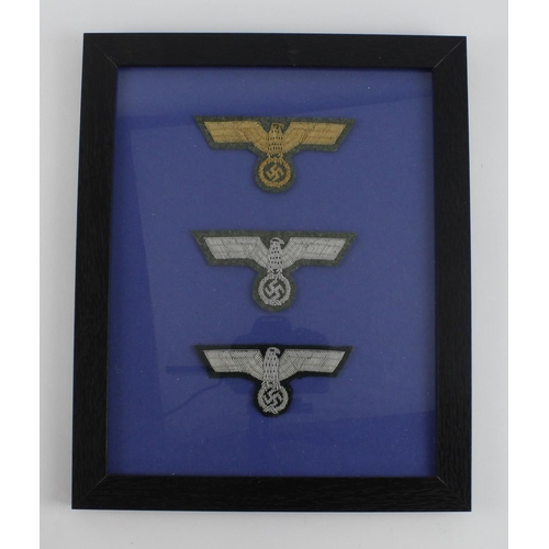 236 - German framed set of three officers breast eagles in frame.