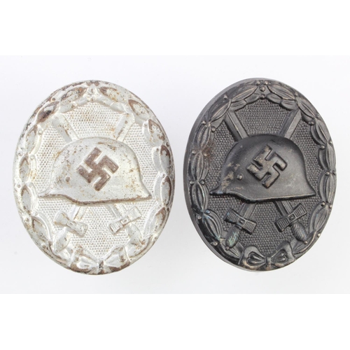 353 - German wounds badges black and silver hollow versions.