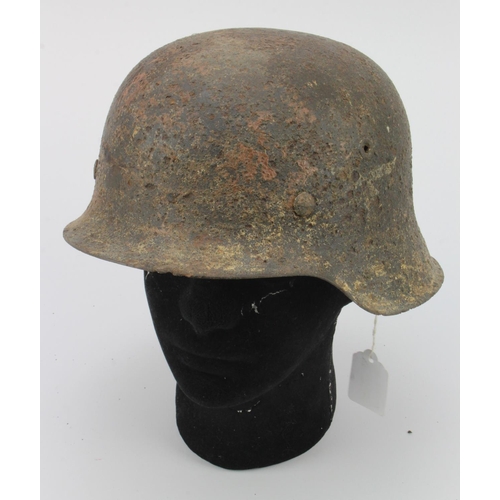 368 - German WW2 1943 pattern raw edge helmet in semi relic condition with its original liner and traces o... 