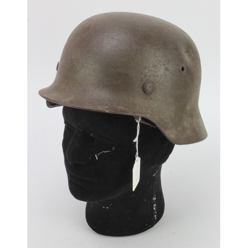 384 - German WW2 Helmet with liner and chin strap. No decals, various numbers / letters stamped to the ins... 