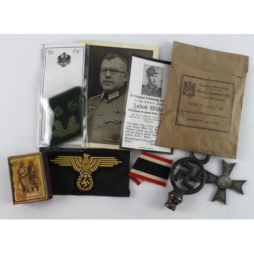 394 - German WW2 packet of mixed items including badges, medals, photos etc.