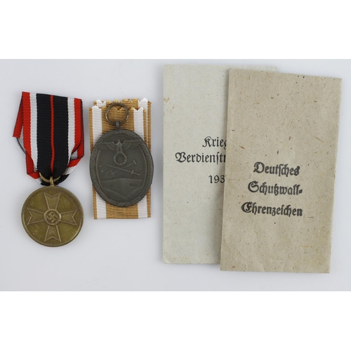 402 - German WW2 West Wall medal and War merit medal both in packets of issue.