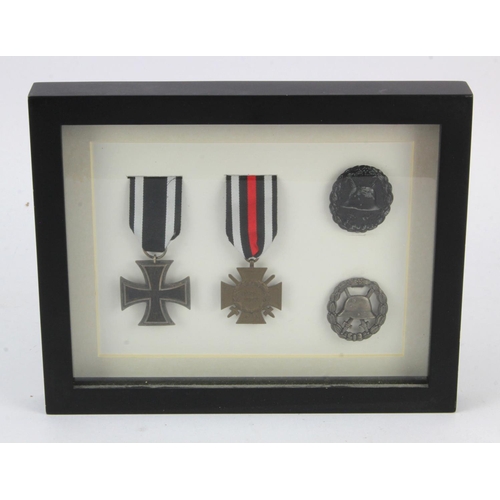 436 - WW1 Medals - EK 2, Veterans Cross with Swords and Black wound badges (2) one voided. Cased.