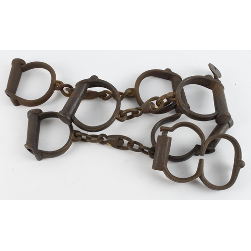 570 - Police Victorian hand cuffs three pairs and set of shackles.