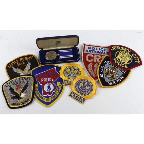 906 - Police LSGC Medal QE2, cased, named (Sergt Anthony G Kiff). Plus 8x US cloth Police patches