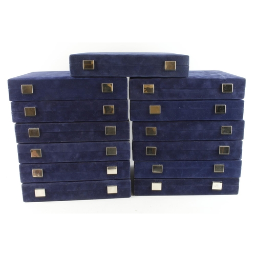 830 - Thirteen blue velvet coin boxes, all 'Westminster' to inner lid and with two tray inserts to each bo... 