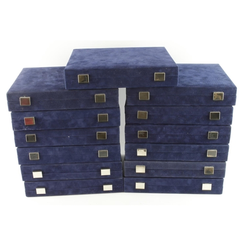 831 - Thirteen blue velvet coin boxes, various designs to inner lids. AF but all noted as good condition