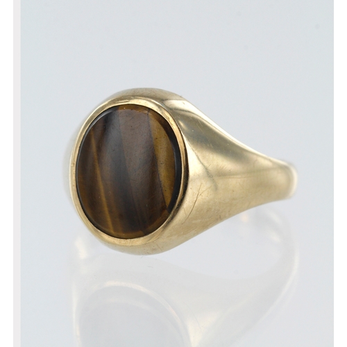 101 - 9ct yellow gold tigers eye signet, table measures 12mm x 10mm, finger size  U, weight 4.9g.