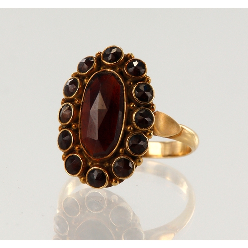 112 - Yellow gold (tests 14ct) vintage cluster ring,set with garnets, head measures 19.5mm x 13mm, finger ... 