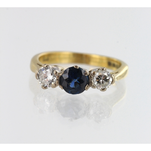 182 - 18ct yellow gold diamond and sapphire trilogy ring, one round 5mm teal sapphire, flanked with a roun... 