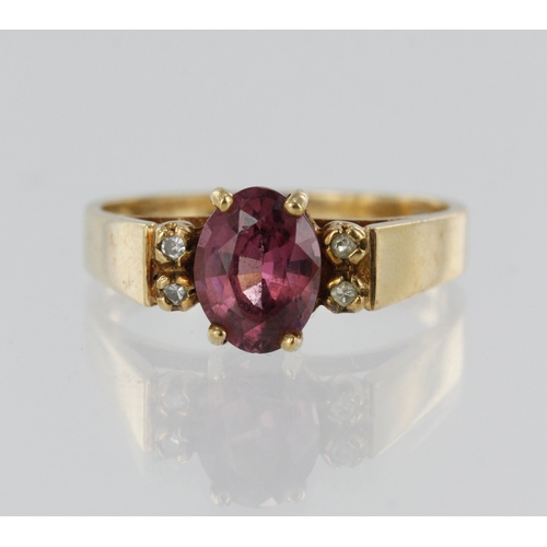 183 - 9ct yellow gold diamond and rhodolite garnet dress ring, garnet measures 8mm x 6mm, four single cut ... 