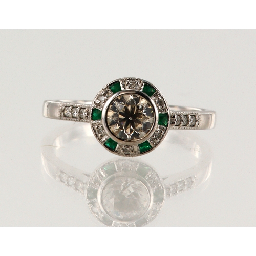 192 - White gold (tests 18ct) diamond and emerald target halo ring, principle round brilliant cut approx. ... 