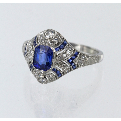 198 - Platinum (tests 850 standard) diamond and sapphire cluster ring, principle emerald-cut sapphire meas... 