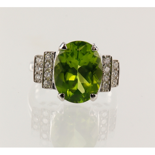 200 - White gold (tests 18ct) diamond and peridot cocktail ring, one oval peridot approx. 5.72ct, measurin... 