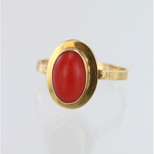 260 - Yellow gold (tests 18ct) coral dress ring, oval cabochon coral measures 10mm x 6mm, finger size M/N,... 