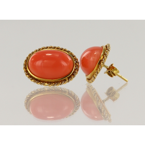 379 - Pair of yellow gold (tests 18ct) coral stud earrings, cabochon coral measures 15mm x 11mm, bezel and... 