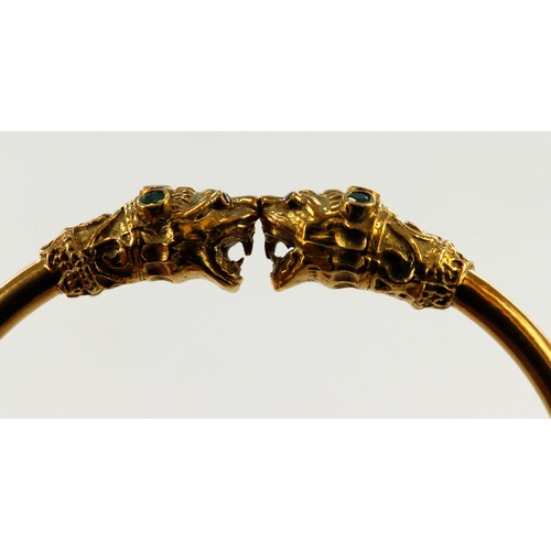 389 - Yellow gold (tests 18ct) double headed dragon bangle, each head set with ruby eyes and three emerald... 