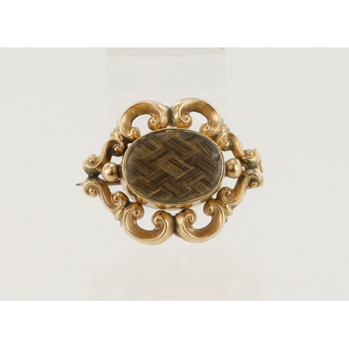 499 - Yellow gold (tests 9ct) Victorian mourning brooch, oval glazed panel over braided hairwork, brooch m... 