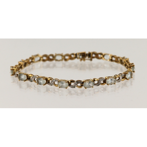 508 - 9ct yellow gold diamond and blue topaz bracelet, fourteen topaz approx. 6mm x 4mm, diamonds highligh... 