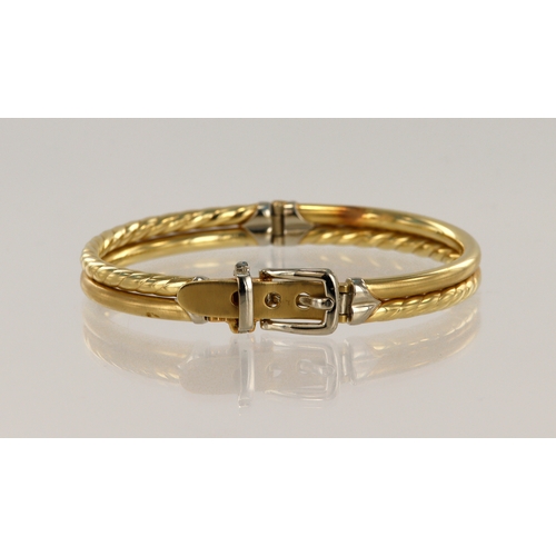 561 - Yellow gold (tests 14ct) hinged buckle bangle, with white gold buckle details, adjustable size insid... 