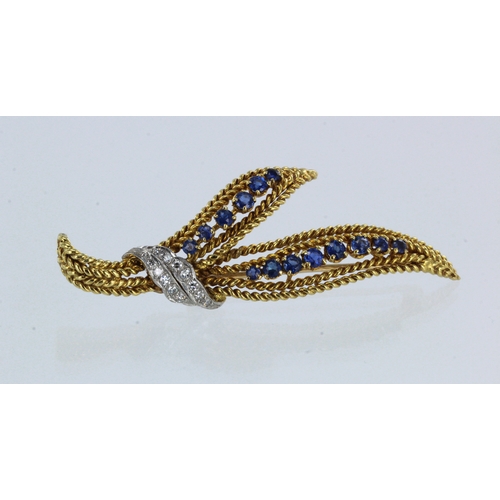 622 - Yellow gold (tests 18ct) diamond and sapphire foliate brooch, twelve diamond highlighted in white go... 