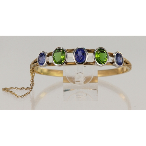 631 - Yellow gold (tests 14ct) diamond, tanzanite and citrine bangle, three graduating oval tanzanites pri... 